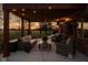 Outdoor patio featuring comfortable seating, brick walls, and strung lights providing a cozy backyard atmosphere at dusk at 8551 E 300 S, Zionsville, IN 46077