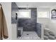 Sleek walk-in shower with dark gray subway tile, a built-in niche, and a marble bench, providing a spa-like experience at 8551 E 300 S, Zionsville, IN 46077