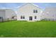 Large backyard with a freshly cut lawn and a fenced perimeter, perfect for recreation at 8654 Tripp Rd, Pendleton, IN 46064