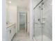 Bright bathroom with a glass shower, double vanity, and marble-like tile flooring throughout at 8654 Tripp Rd, Pendleton, IN 46064