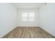 Minimalist bedroom with vinyl flooring and a window providing ample natural light at 8654 Tripp Rd, Pendleton, IN 46064