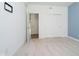 Bedroom featuring soft carpet, blue accent wall, double closet doors, and bright natural lighting at 8654 Tripp Rd, Pendleton, IN 46064