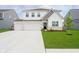 Charming two-story home with a well-manicured lawn and a spacious three-car garage at 8654 Tripp Rd, Pendleton, IN 46064