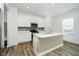 Stylish kitchen island with stainless steel appliances, white cabinets and modern countertops at 8654 Tripp Rd, Pendleton, IN 46064