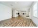 Open concept living room showing kitchen with stainless steel appliances and a modern design at 8654 Tripp Rd, Pendleton, IN 46064