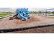 Community playground with slides and swings adjacent to a scenic pond at 8654 Tripp Rd, Pendleton, IN 46064