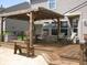 Cozy deck with wooden pergola featuring string lights, a table, and chairs for outdoor entertainment at 9045 Stones Bluff Pl, Indianapolis, IN 46113