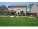 Spacious backyard showcasing a wooden deck with pergola, lush green lawn and garden at 9045 Stones Bluff Pl, Indianapolis, IN 46113