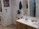 Bathroom featuring a double sink vanity, mirror, toilet and a view through a doorway to another room at 9045 Stones Bluff Pl, Indianapolis, IN 46113