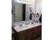 Bathroom with double vanity sinks, a large mirror, and convenient storage below, ideal for getting ready at 9045 Stones Bluff Pl, Indianapolis, IN 46113