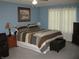 Comfortable bedroom featuring a queen-sized bed, nightstands, and a dresser at 9045 Stones Bluff Pl, Indianapolis, IN 46113