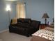 Cozy bedroom featuring a loveseat and large window at 9045 Stones Bluff Pl, Indianapolis, IN 46113