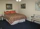 Comfortable bedroom featuring a plaid bedspread, side table, and bench at 9045 Stones Bluff Pl, Indianapolis, IN 46113