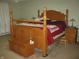 Elegant bedroom with a four-poster bed, matching nightstand, and carpet flooring at 9045 Stones Bluff Pl, Indianapolis, IN 46113