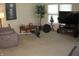 Bright living room with natural light, with exercise equipment and an entertainment center at 9045 Stones Bluff Pl, Indianapolis, IN 46113