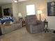 Carpeted living room with comfortable seating and a large window for natural light at 9045 Stones Bluff Pl, Indianapolis, IN 46113