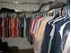 Spacious walk-in closet provides ample storage with hanging racks and shelving, maximizing organization and convenience at 9045 Stones Bluff Pl, Indianapolis, IN 46113