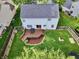 Aerial view of the backyard with a wooden deck, seating, fenced yard, and a well-kept lawn at 9099 Merrill Ct, Fishers, IN 46038