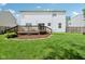 Exterior view of a home featuring a back deck, spacious yard, and mature trees at 9099 Merrill Ct, Fishers, IN 46038