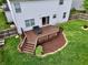A spacious backyard deck with a seating area and stairs leading down to a well-manicured lawn at 9099 Merrill Ct, Fishers, IN 46038