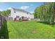 A large, well-maintained backyard with a deck, green grass, and partial fence at 9099 Merrill Ct, Fishers, IN 46038