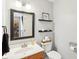 Clean and well-lit powder room with a mirror, toilet, vanity, and tasteful decor creating a functional and aesthetically pleasing space at 9099 Merrill Ct, Fishers, IN 46038