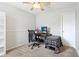 This carpeted bedroom features a ceiling fan and ample natural light, providing a comfortable workspace at 9099 Merrill Ct, Fishers, IN 46038