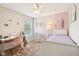 This bedroom features a ceiling fan, a cozy hammock chair, and a well-lit desk space, creating a charming ambiance at 9099 Merrill Ct, Fishers, IN 46038