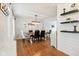 Stylish dining room with a modern chandelier, sleek wooden table, and beautiful hardwood floors at 9099 Merrill Ct, Fishers, IN 46038