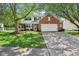 Charming two-story home with a brick and vinyl facade, featuring a well-manicured lawn and a spacious driveway at 9099 Merrill Ct, Fishers, IN 46038