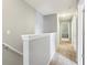 A bright, carpeted hallway features neutral wall colors and multiple doors, leading to various rooms in the home at 9099 Merrill Ct, Fishers, IN 46038