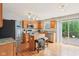 An open kitchen design with stainless steel appliances, an island with seating, and sliding glass doors to the outside deck at 9099 Merrill Ct, Fishers, IN 46038