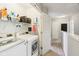 This functional laundry room features modern appliances and convenient storage shelves for laundry essentials at 9099 Merrill Ct, Fishers, IN 46038