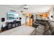 Relax in a modern living room with a stone fireplace, hardwood flooring, and a large sectional couch for cozy gatherings at 9099 Merrill Ct, Fishers, IN 46038