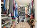 A well-organized walk-in closet with shelves, rods, and shoe racks for ample storage at 9099 Merrill Ct, Fishers, IN 46038