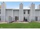 Back exterior of a townhouse with a fenced patio and grassy yard at 9467 Sandpiper W Dr, Indianapolis, IN 46268