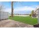 Backyard with a patio and lawn overlooking a serene community lake at 9467 Sandpiper W Dr, Indianapolis, IN 46268
