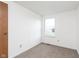 A clean bedroom features neutral carpet, a window for light, and minimalist decor, perfect for relaxation at 9467 Sandpiper W Dr, Indianapolis, IN 46268
