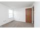 Bedroom with a bright window, neutral carpet, and a closet door at 9467 Sandpiper W Dr, Indianapolis, IN 46268