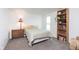 A bright bedroom features a cozy reading nook with natural light, accompanied by a built-in bookshelf at 9467 Sandpiper W Dr, Indianapolis, IN 46268