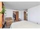 Bright bedroom features a comfortable armchair, neutral carpet, and access to closet and ensuite bathroom at 9467 Sandpiper W Dr, Indianapolis, IN 46268