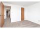 Bedroom featuring neutral carpet, white walls, and convenient closet storage at 9467 Sandpiper W Dr, Indianapolis, IN 46268