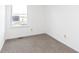 A cozy bedroom offers neutral carpet, natural light from the window, and a serene atmosphere at 9467 Sandpiper W Dr, Indianapolis, IN 46268
