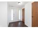 Inviting entryway features dark wood floors, a white front door with sidelights, and neutral walls at 9467 Sandpiper W Dr, Indianapolis, IN 46268