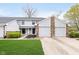Charming townhouse with well-maintained lawn and attached two-car garage in a residential neighborhood at 9467 Sandpiper W Dr, Indianapolis, IN 46268