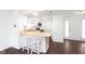 Open kitchen with a breakfast bar, stainless steel appliances, and access to the front entry door at 9467 Sandpiper W Dr, Indianapolis, IN 46268