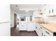 Modern kitchen with adjacent living area, featuring a breakfast bar and ample counter space at 9467 Sandpiper W Dr, Indianapolis, IN 46268