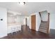 Open-concept living room with breakfast bar, hardwood floors and adjacent staircase to the second floor at 9467 Sandpiper W Dr, Indianapolis, IN 46268