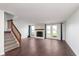 Spacious living room with fireplace and French doors leading to outdoor space. Large hardwood floors at 9467 Sandpiper W Dr, Indianapolis, IN 46268