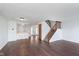 Well-lit living area featuring hardwood floors, an open-concept kitchen, and stairway to the second floor at 9467 Sandpiper W Dr, Indianapolis, IN 46268